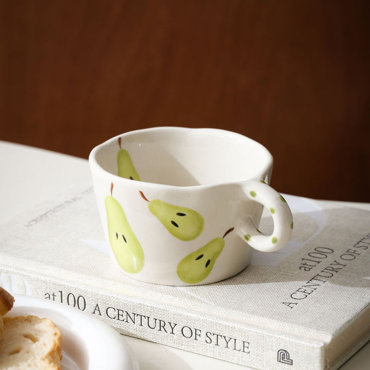Ceramic mug with hand-painted banana illustration and round handle
