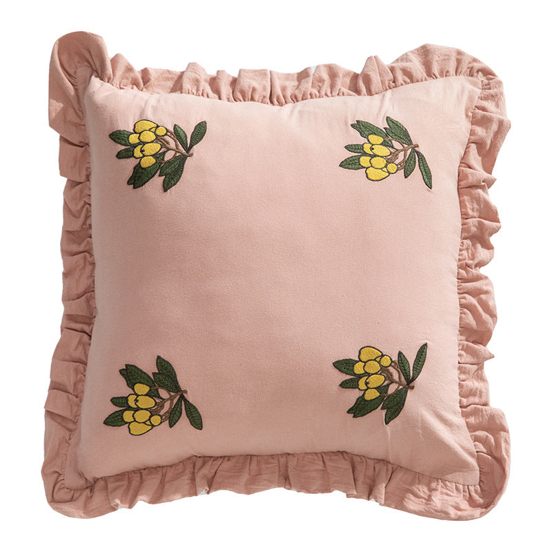 Square decorative pillow with ruffled edges and hand-stitched flower appliqués