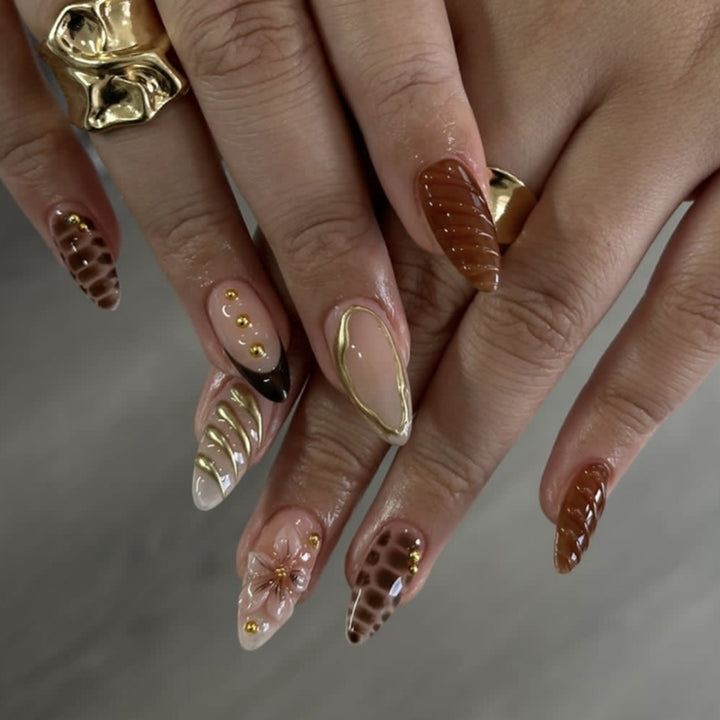 Artificial nails in modern stiletto design with golden accents Kalsten