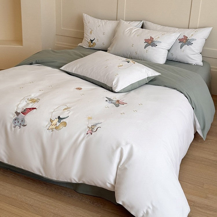 Children's bedding set with embroidered fairy tale forest motifs and reversible option