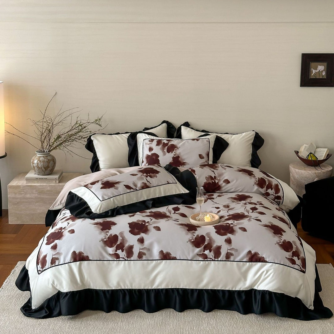 Satin bedding set with watercolored floral print, contrasting piping and flowing ruffles