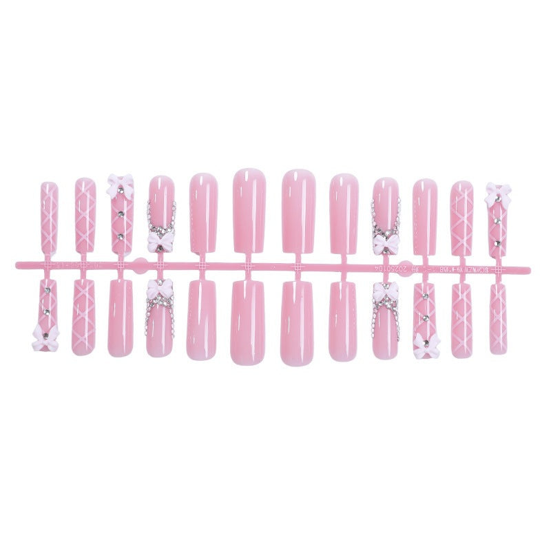 Acrylic nail set with elegant bow and glitter accents Kalsten
