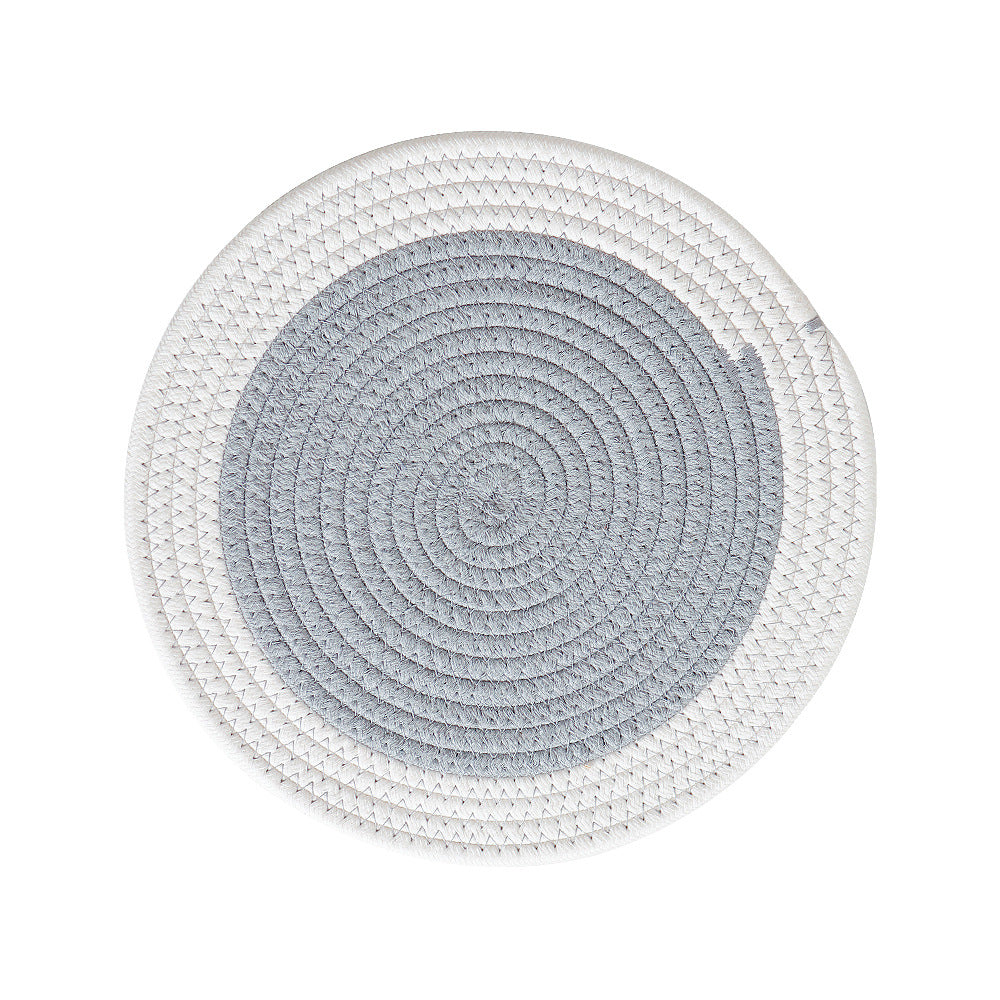 Round handwoven table placemat made of cotton yarn with structured spiral binding