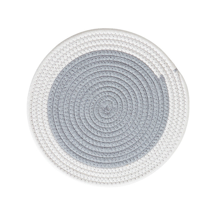 Round handwoven table placemat made of cotton yarn with structured spiral binding