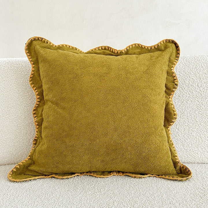 Decorative velvet cushion with wavy edge and decorative stitching