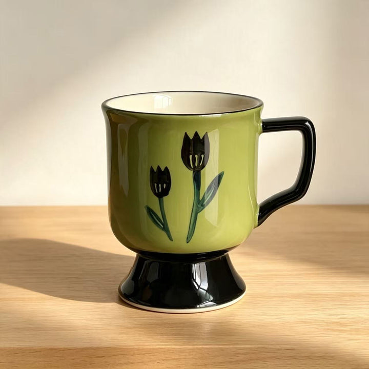 Ceramic cup with foot and hand-painted tulip motif