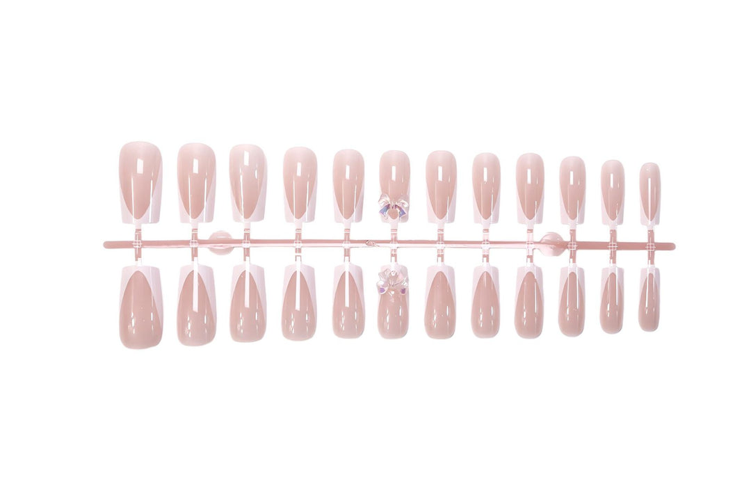 Artificial nail set with luxurious French tips and elegant jewelry embellishments Kalsten