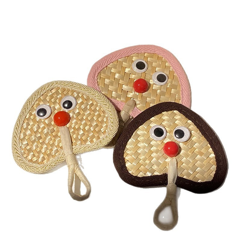 Handcrafted fan with playful face motif Kalsten