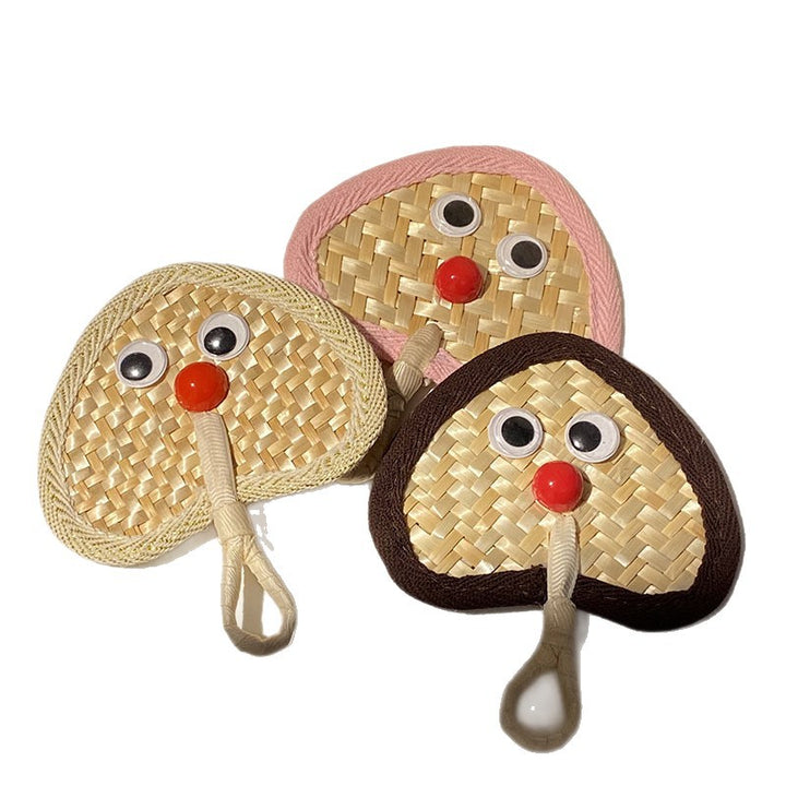 Handcrafted fan with playful face motif Kalsten