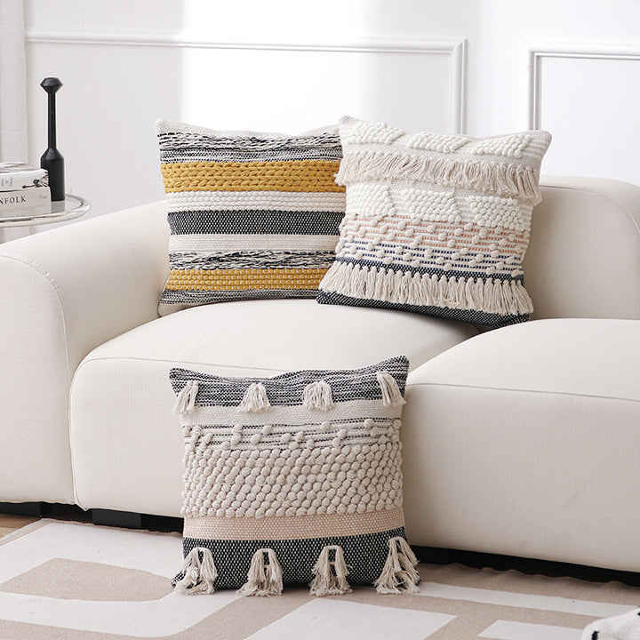 High-structured woven decorative cushion cover with fringes and bouclé application
