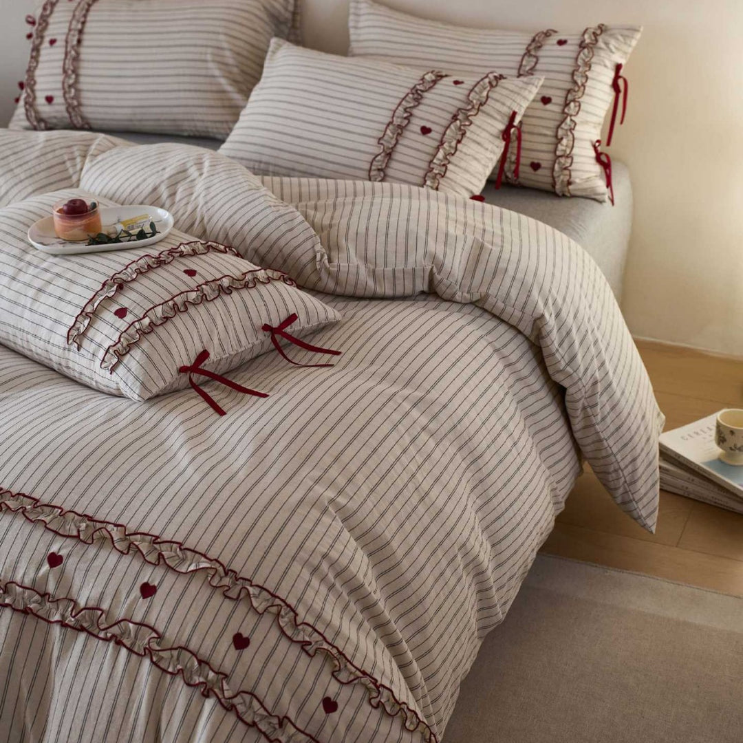 Striped bedding set with ruffles and heart applique