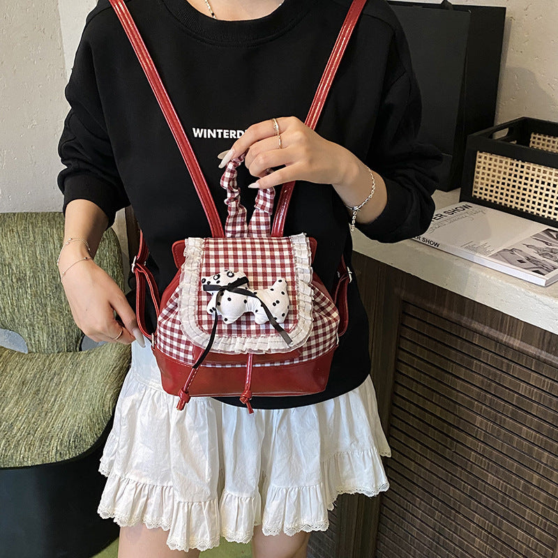 Playful backpack with checkered pattern and animal appliqué Kalsten