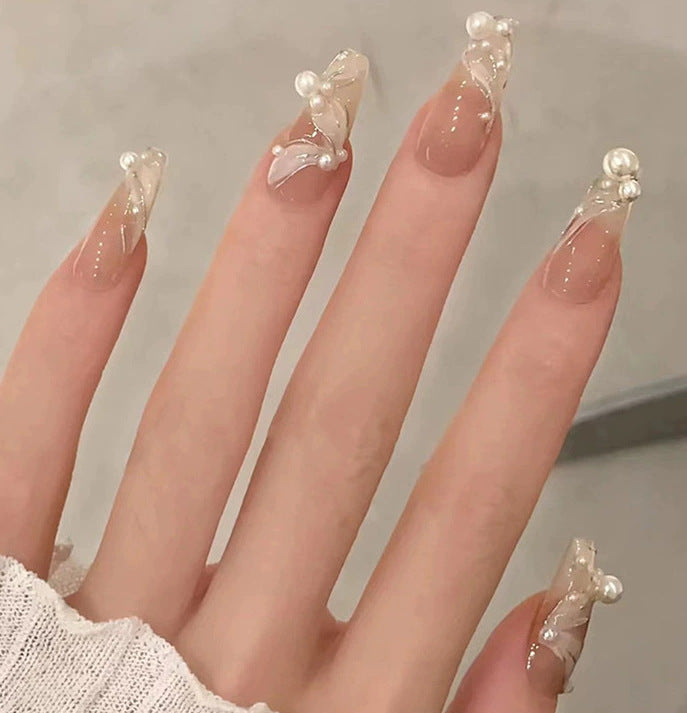 Elegant nail design with pearl embellishment Kalsten