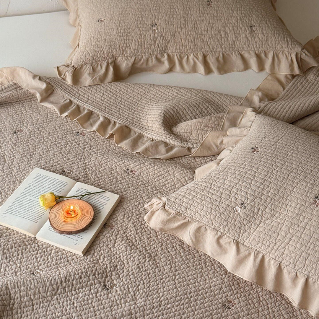 Quilted bedspread and cushion set with frill and delicate flower embroidery