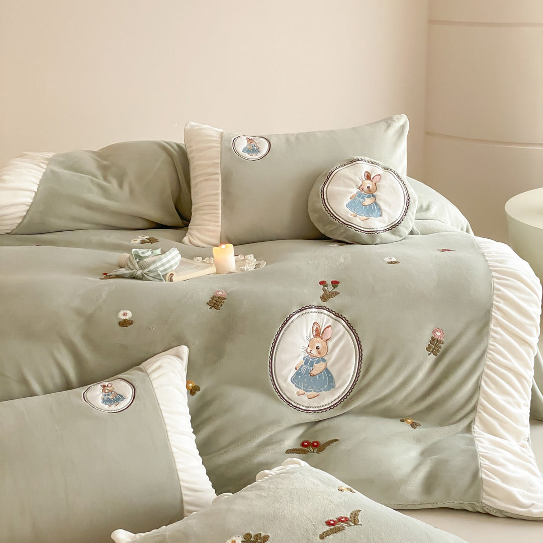 Quilted children's bedding set with embroidered bunny appliqués and ruffles