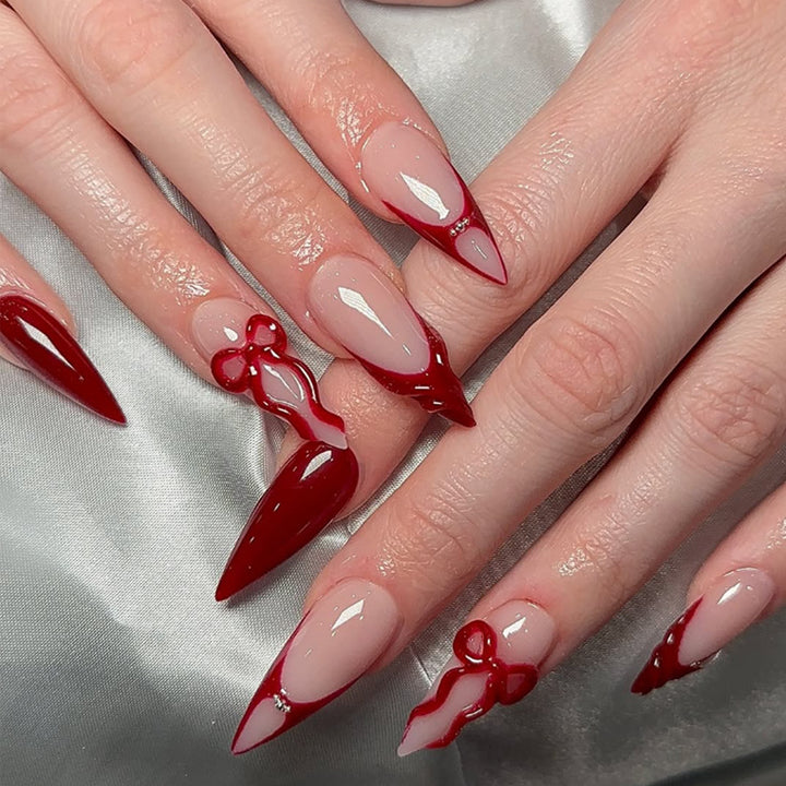 Artificial nails with elegant pointed designs and creative embellishments Kalsten