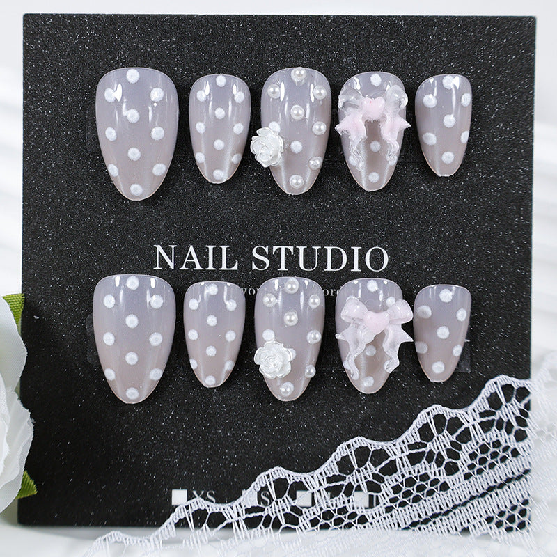 Art nail set with playful dots and romantic embellishments Kalsten