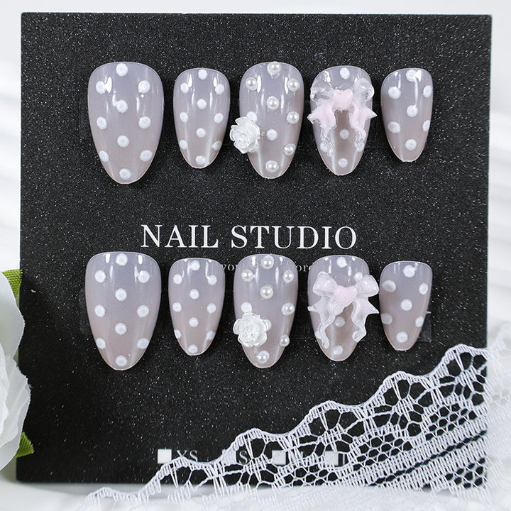 Art nail set with playful dots and romantic embellishments Kalsten