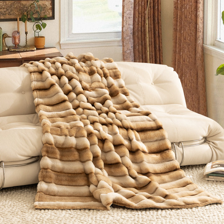 Luxurious faux fur throw blanket with relief-style quilting