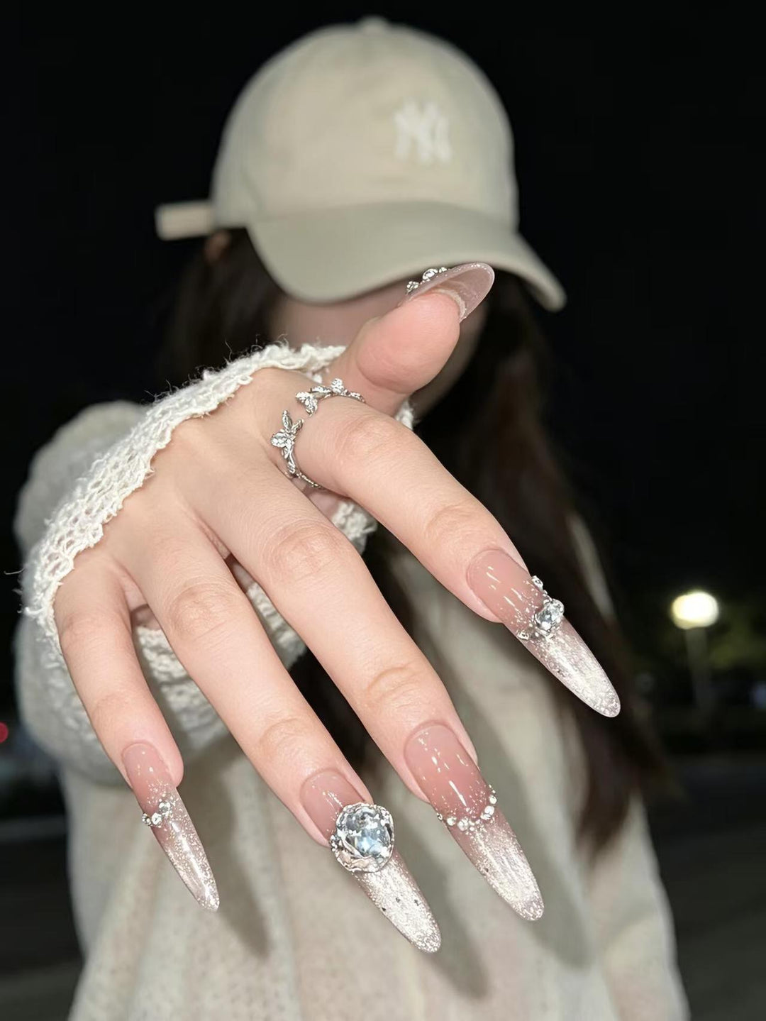Artistic Stiletto Nail Enhancements with Gemstone Accents
