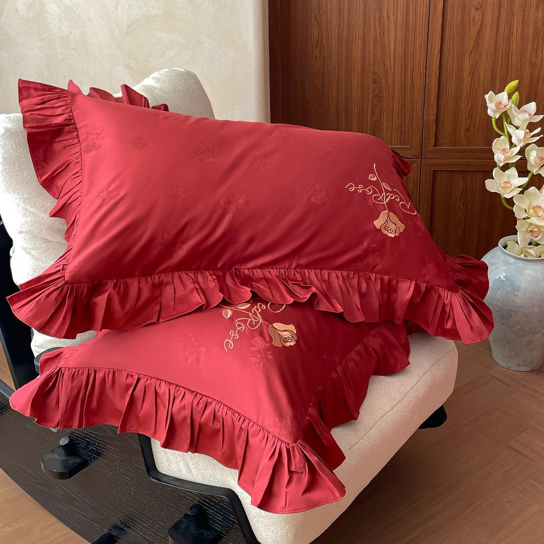 Romantic satin bedding set with ruffles, fine floral embroidery, and reversible pillowcase