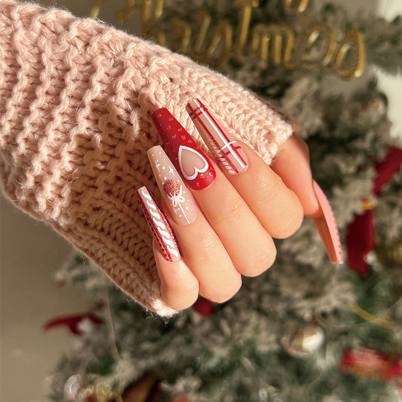 Artful nail art in festive design with heart and Christmas motifs Kalsten