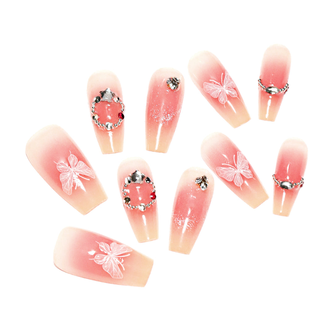 Artificial nail extensions with floral design and sparkling accents Kalsten