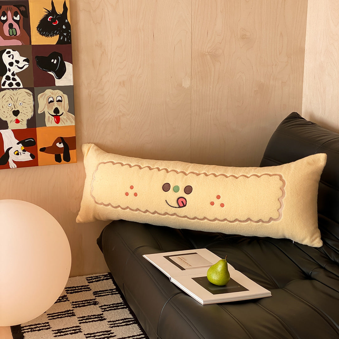 Extra-long plush sofa cushion with appliqués and plush feet