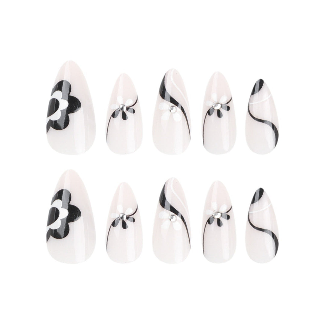 Artistic nail extensions with floral accents and glitter accents Kalsten
