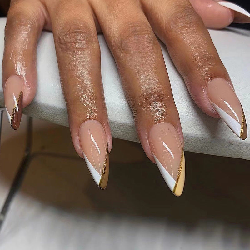 Artful nail art in elegant stiletto design with golden accents Kalsten