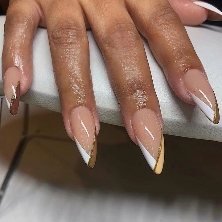 Artful nail art in elegant stiletto design with golden accents Kalsten