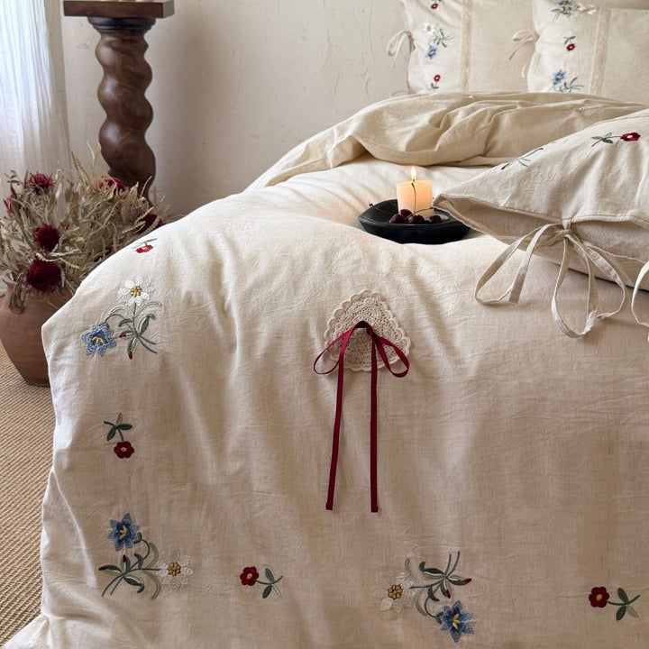 Bedding set made of linen look with floral embroidery and bow closure