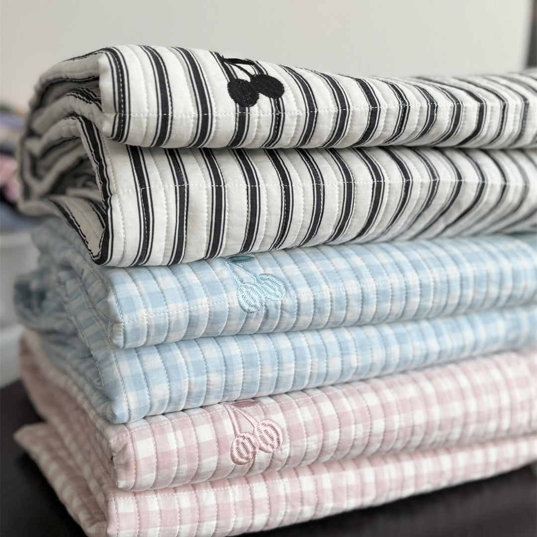 Quilted cotton bedspread with fine striped texture and cherry embroidery