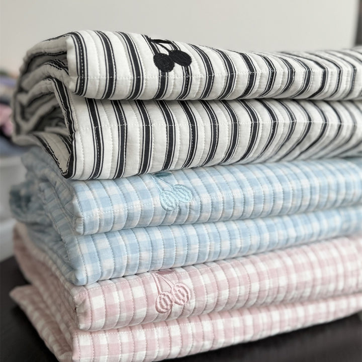 Quilted cotton bedspread with fine striped texture and cherry embroidery