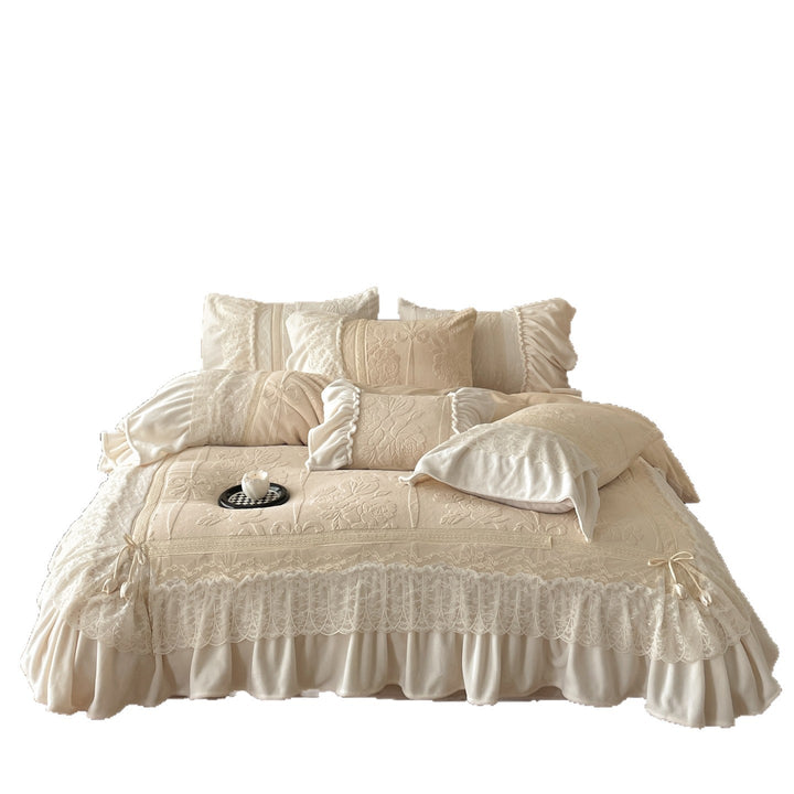 Luxury bedding set with quilted coverlet, lace ruffle, and decorative bed skirt