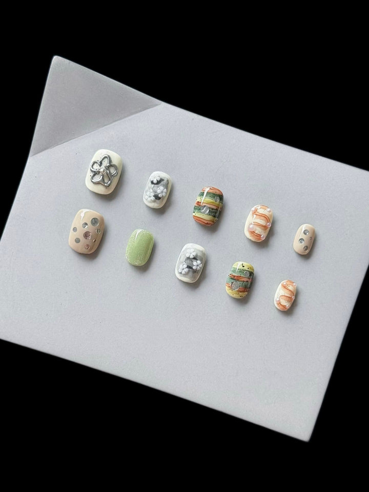 Artistic Press-On Nail Set with Floral and Textured Designs