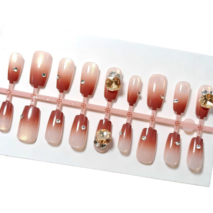 Artificials nails in elegant ombre style with rhinestone embellished applications Kalsten