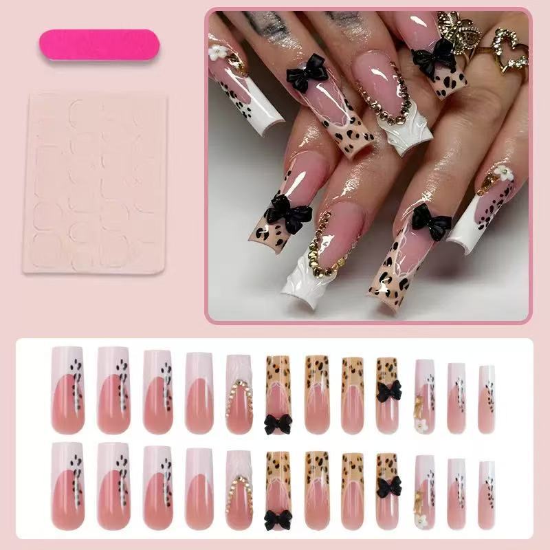 Artistic Press-On Nail Design with Bow and Animal Print Accents Kalsten