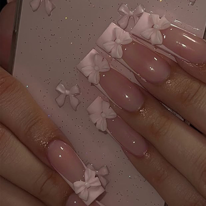Artificial nail set with shimmering details and cute bows Kalsten