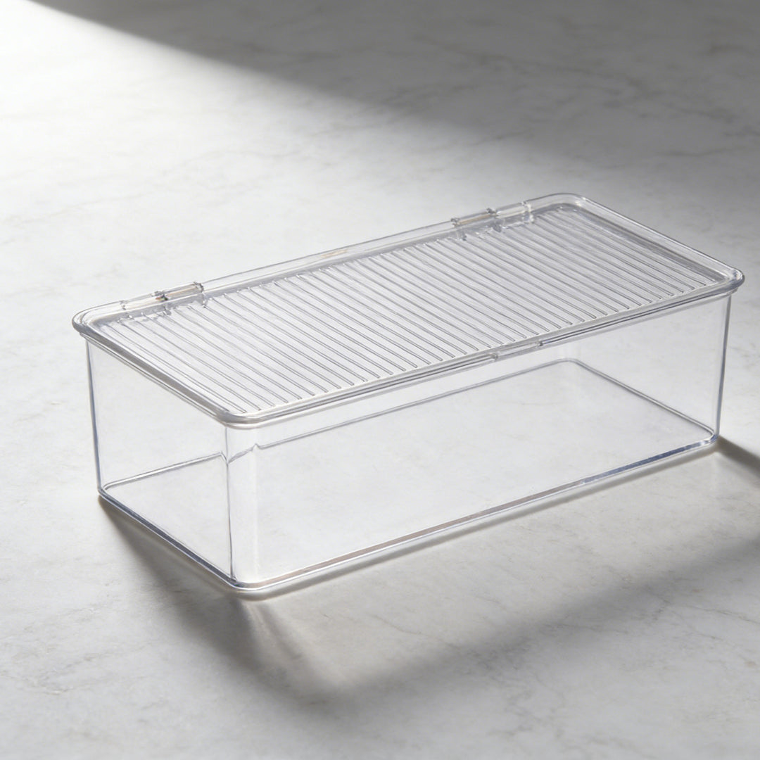 Transparent storage box with flip closure and ribbed lid surface