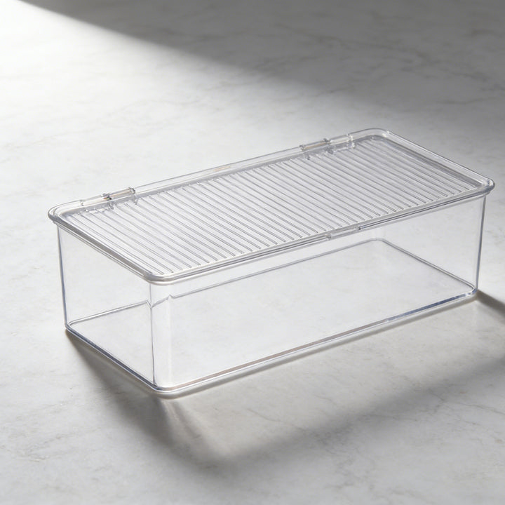 Transparent storage box with flip closure and ribbed lid surface