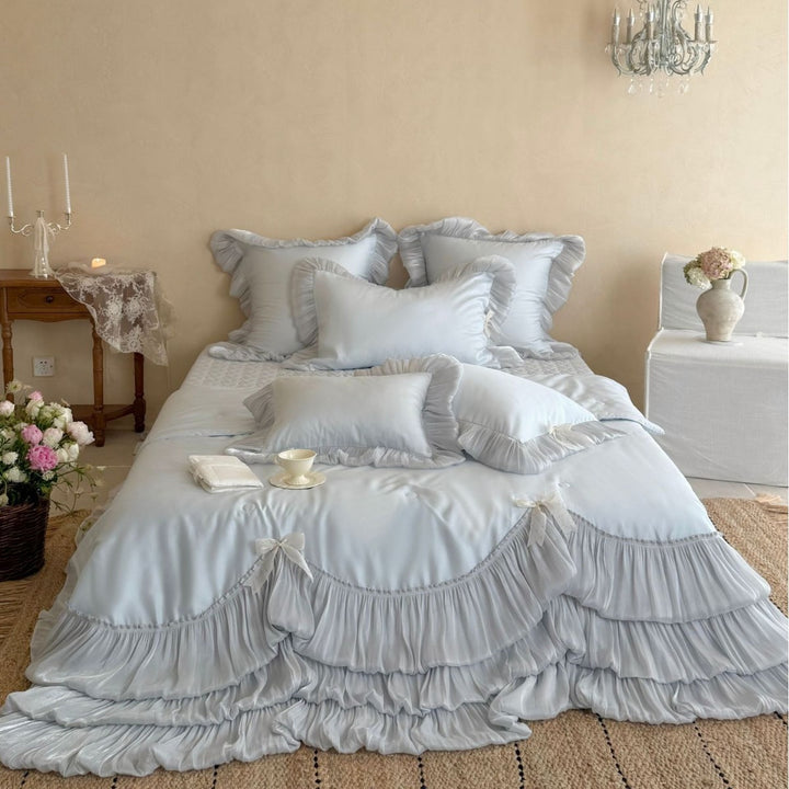 Romantic satin bedding and bedspread set with decorative ruffles and bows