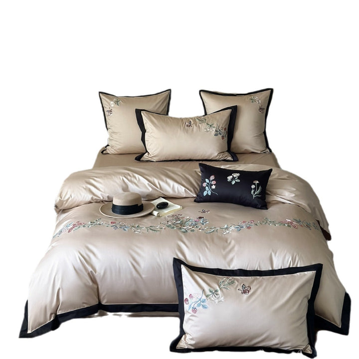 Luxurious embroidered satin bedding set with contrast piping and decorative pillow