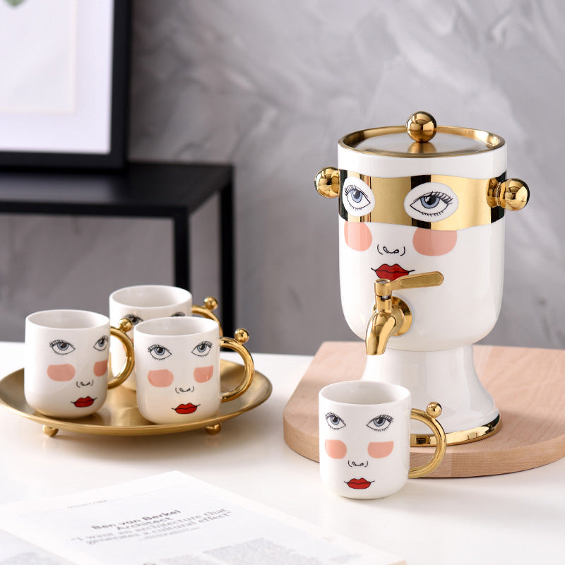 Decorative ceramic beverage dispenser with tap, hand-painted face and gold-finished lid