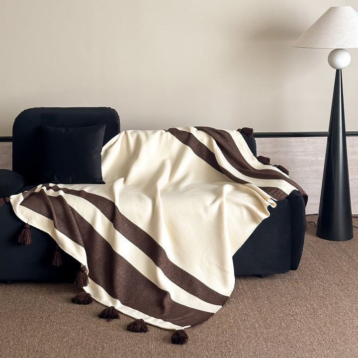 Soft woven blanket with tassels and diagonal stripes