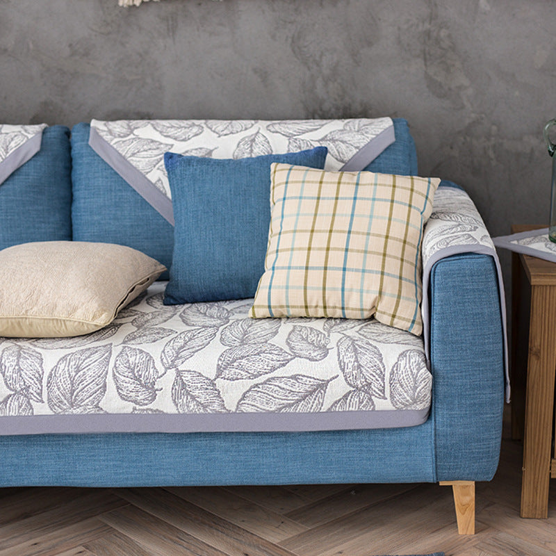 Universal sofa protective cover for three-seater with leaf print, non-slip underside and separate armrest covers Kalsten