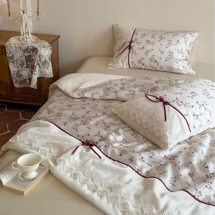 Luxurious cotton satin duvet cover set with lace trim, floral all-over embroidery, and decorative ribbons