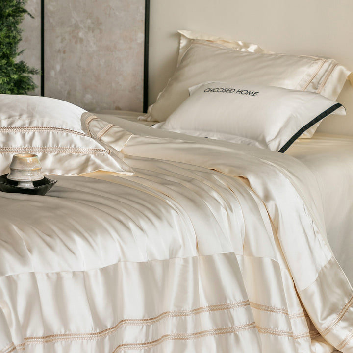 Luxurious satin bedding set with decorative borders and silky-smooth feel
