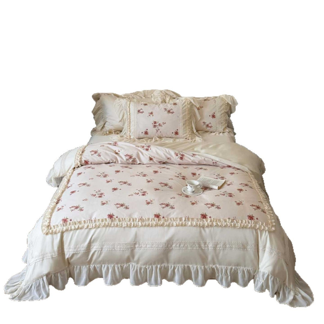 Luxury bedding set made of cotton satin with a ruffled bed skirt, lace trim, and quilted vintage blanket