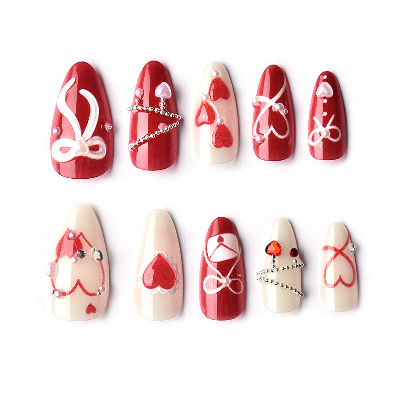 Glamorous artificial nail set with romantic heart design and elegant embellishments Kalsten